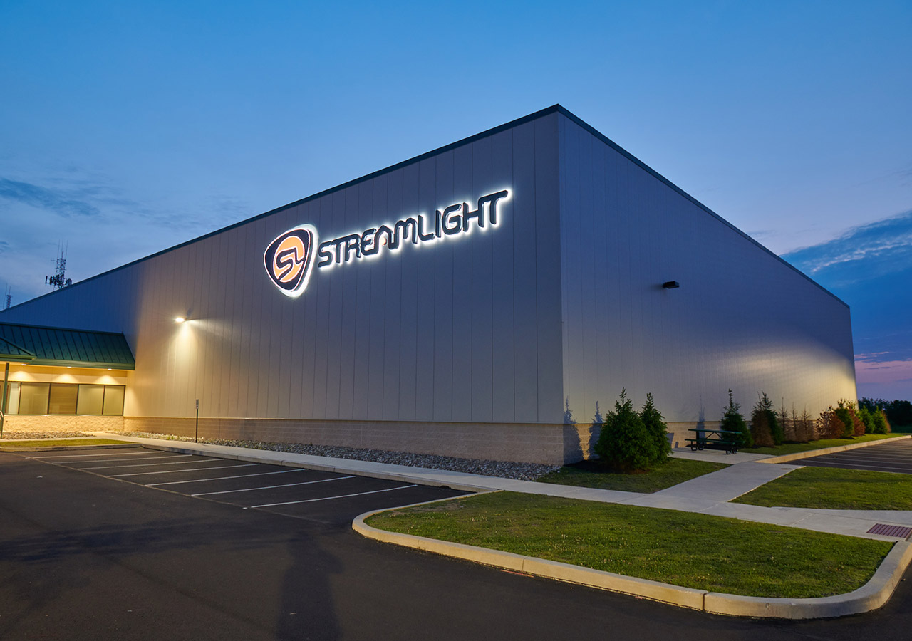 The nighttime exterior of Streamlight Inc. headquarters with a light up sign that reads Streamlight.