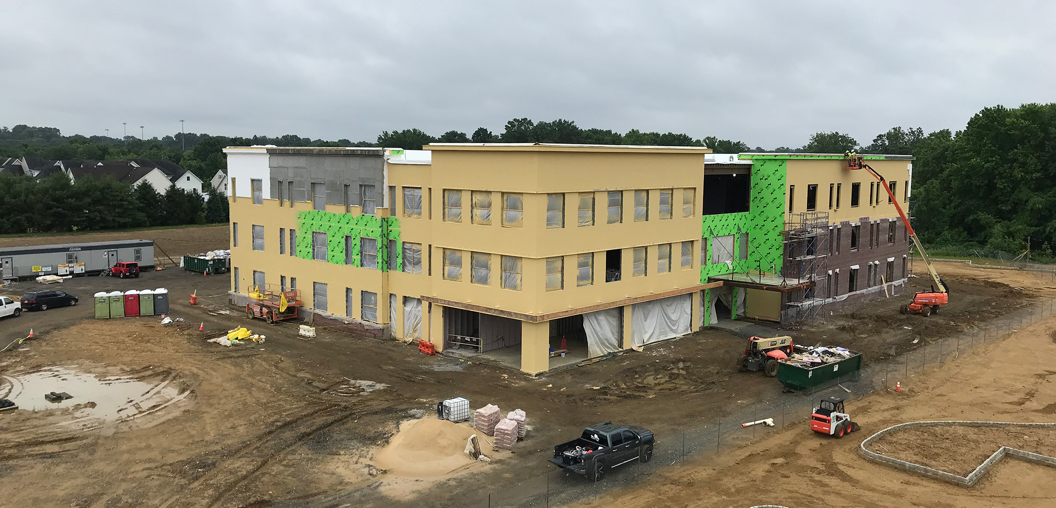 An angle view of Bordentown Medical Office Building with tan stucco exterior and many windows under construction.