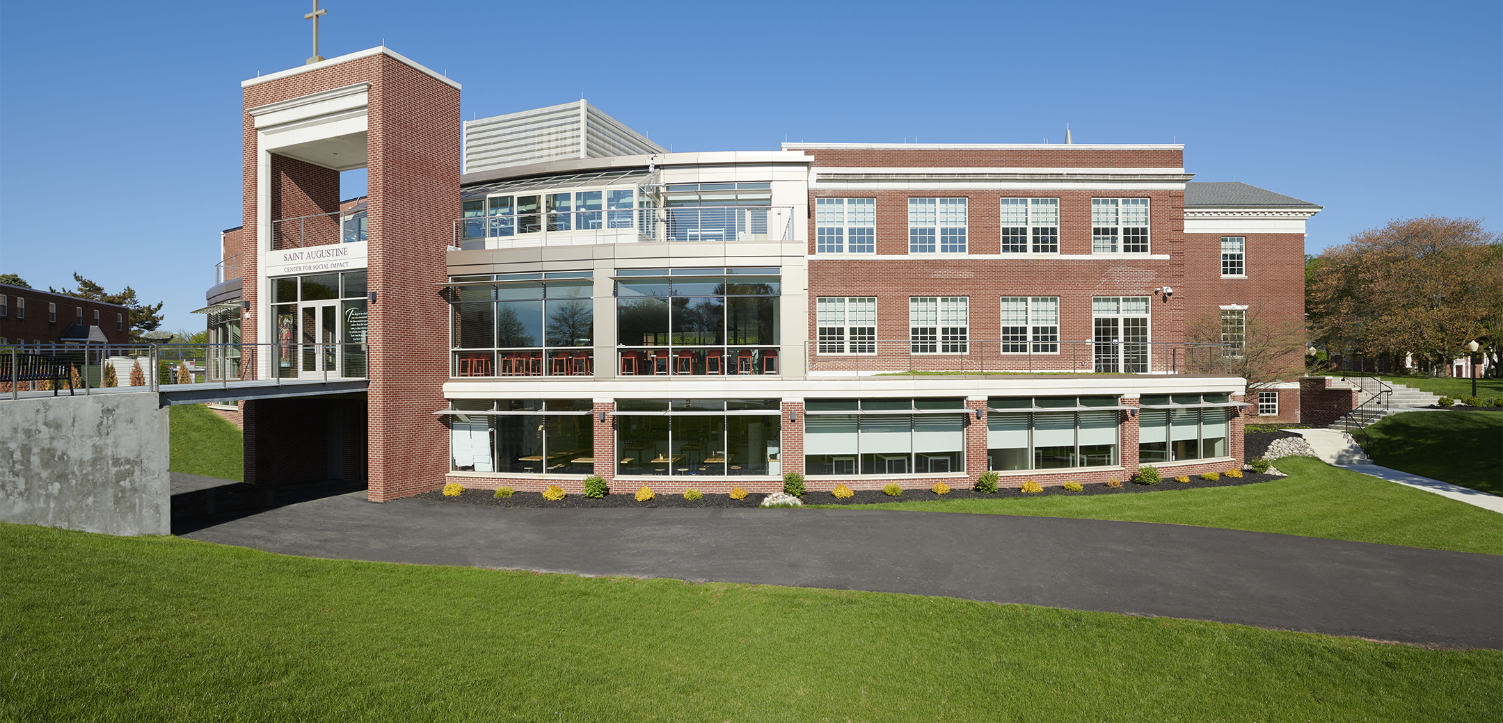 The exterior of Malvern Prep 3-story building showcasing the bridge leading to the front entrance on the second floor over the driveway on the ground floor.