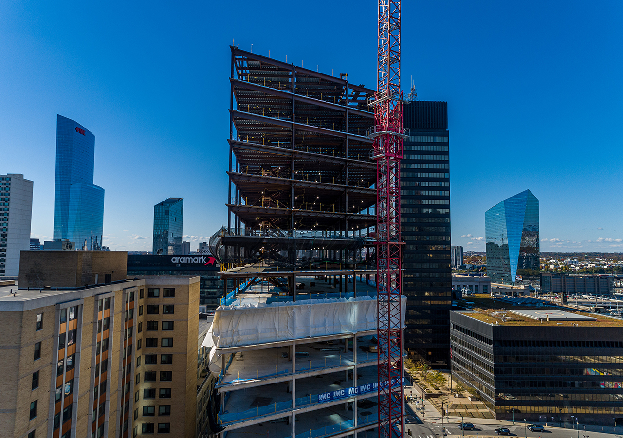 2222 Market Street, a large law firm office building under construction with Philadelphia in the background.