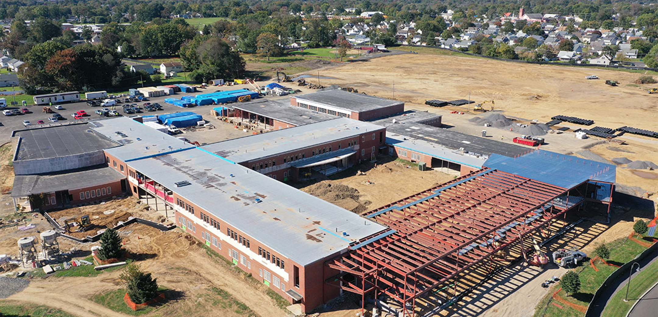 A drone aerial image of the Ben Franklin Middle School during the construction process showcasing the framework and finished parts of the building.