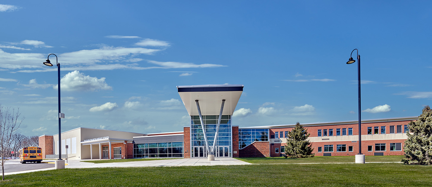 The exterior of Ben Franklin Middle School featuring an entryway to the front of the school with a glass windows