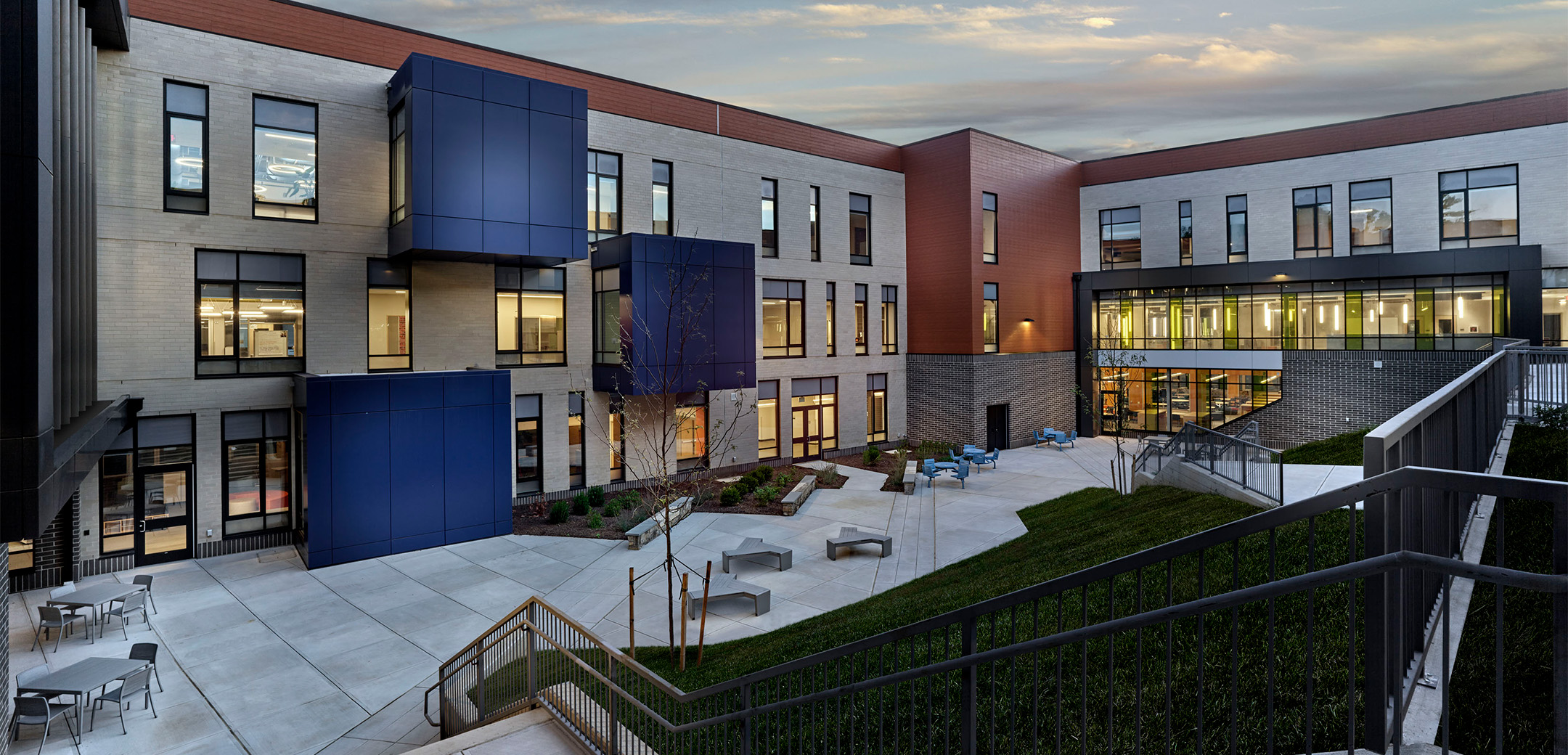 The exterior backside of Black Rock Middle School featuring a terrace enclosed within the building walls.
