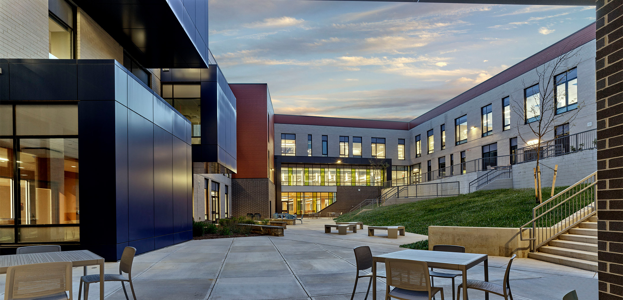 The exterior backside of Black Rock Middle School featuring a terrace enclosed within the building walls.