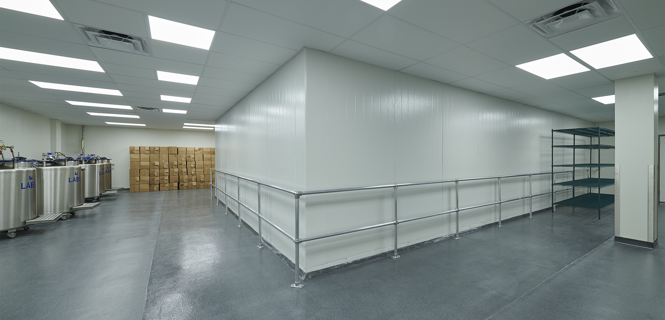 A view of the Charles River Cold Room back corner, showcasing the metal containers, wall railings and boxes in the background.