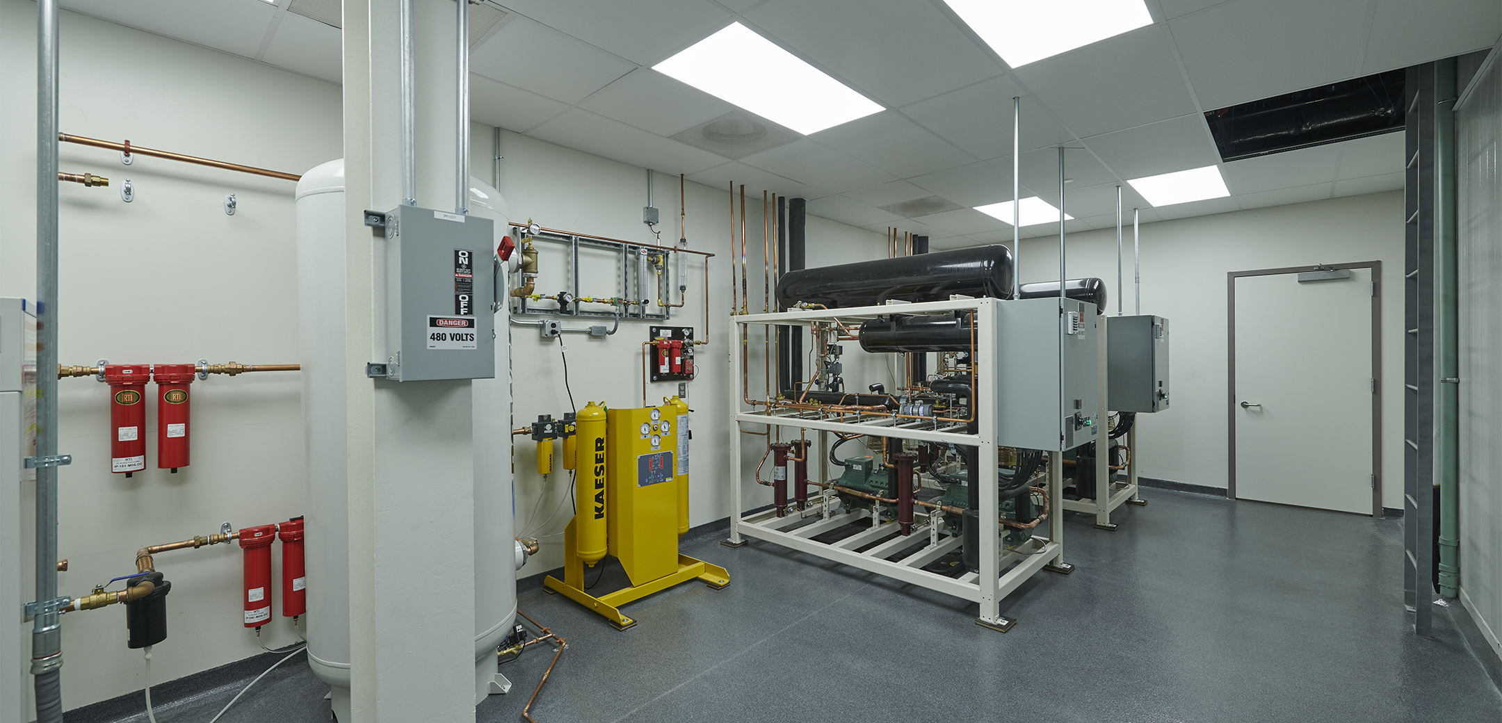 A view of the Charles River cold room showcasing the machinery and pressure chambered containers that have pipes routed out of them.