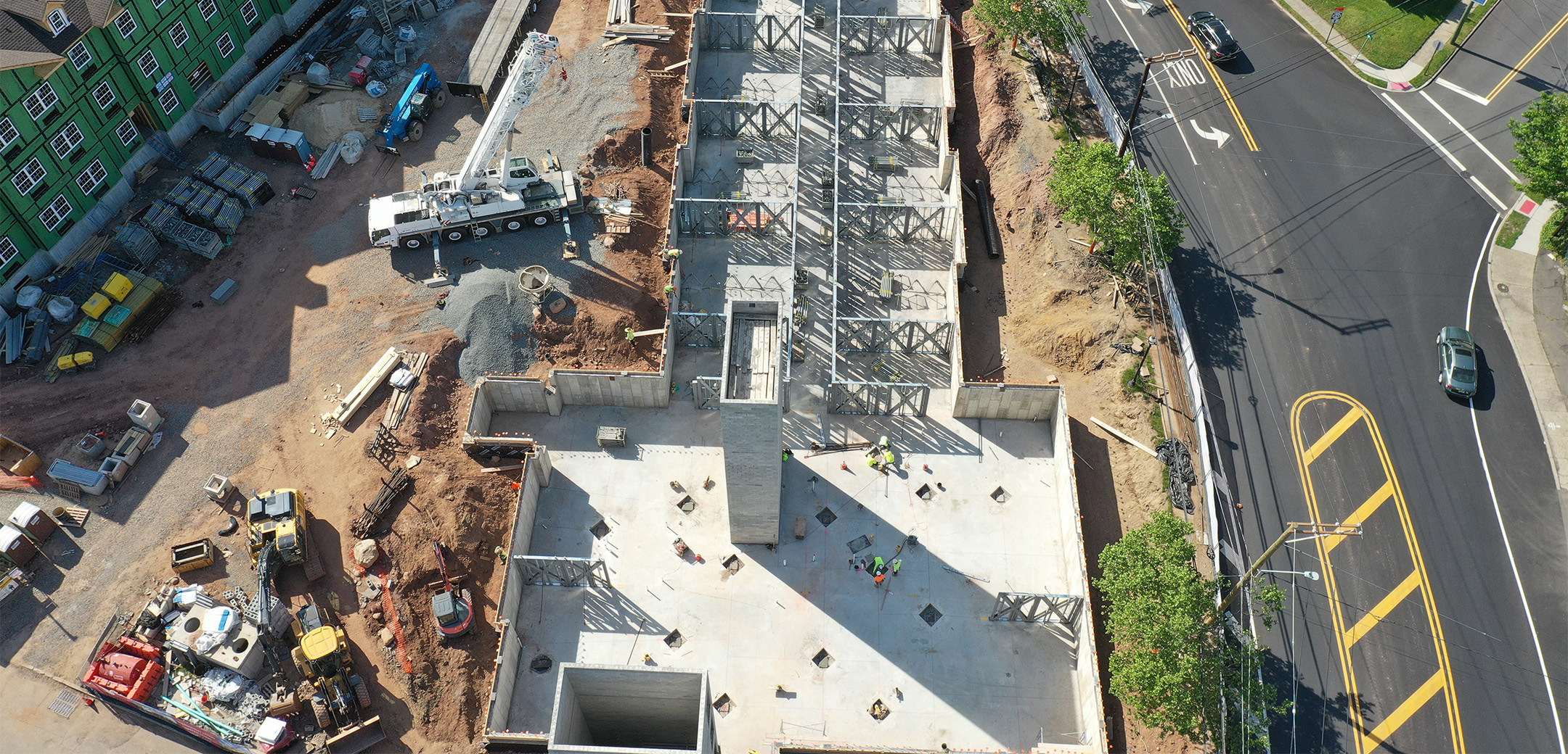 The aerial view looking down at one of the Chelsea Senior Living buildings under construction with cement.