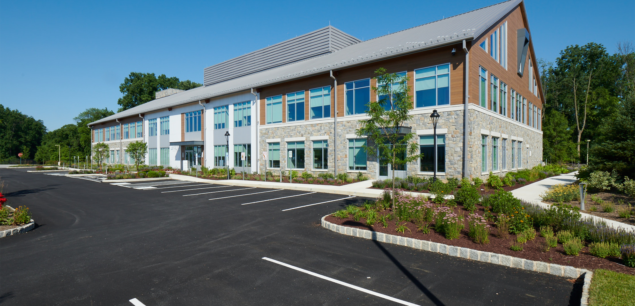 The back view of Equus Capital Partners headquarters featuring the landscaping and patio in front.