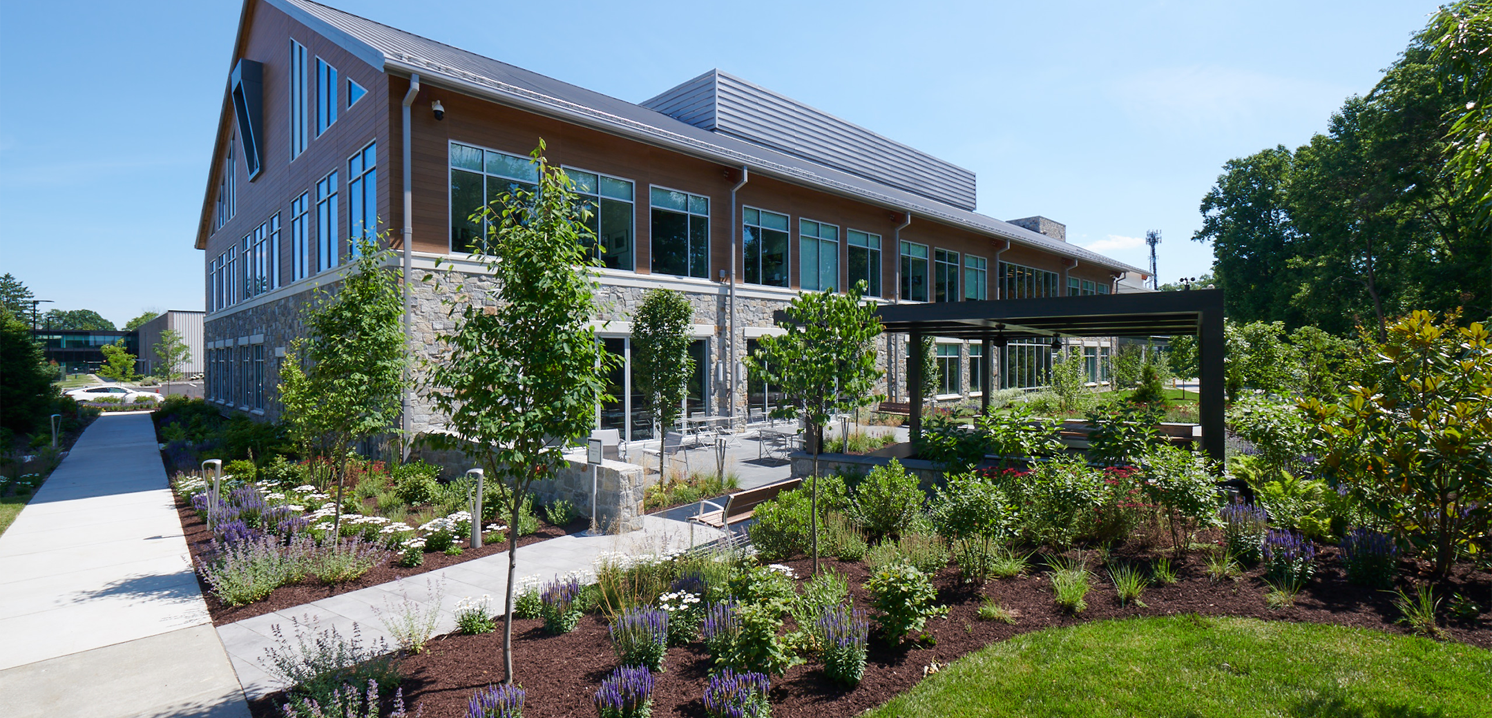 The back view of Equus Capital Partners headquarters featuring the landscaping and patio in front.