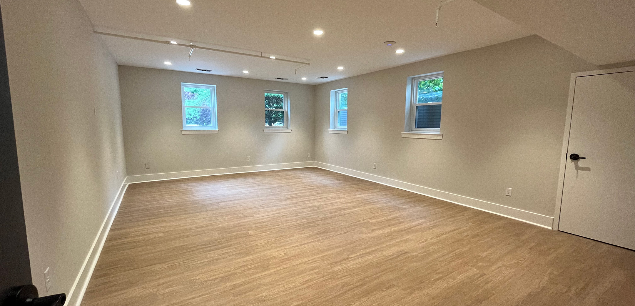 An empty room of Philadelphia Integrative Psychiatry with wood floors and white walls.