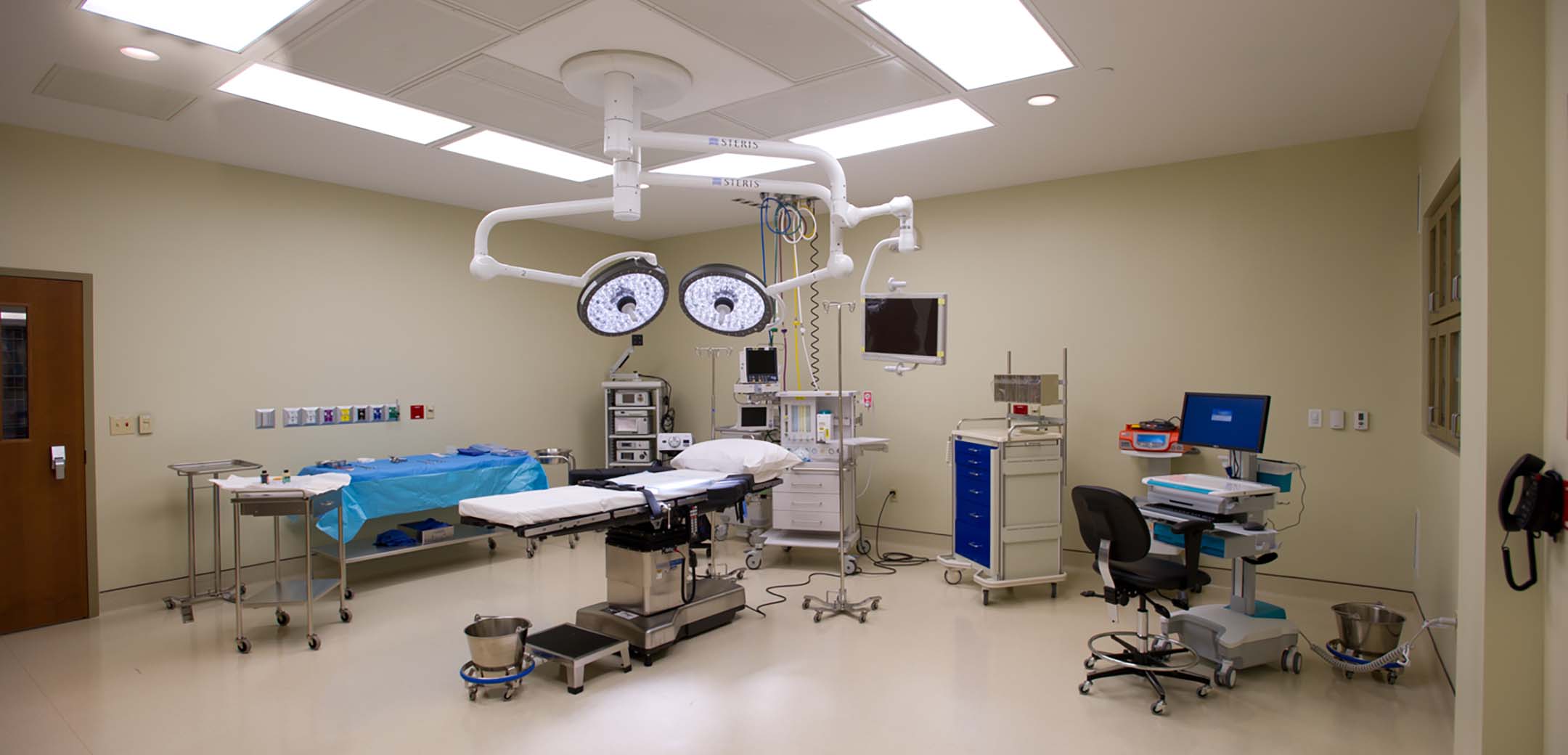 The interior view of the Physician Care Surgical hospital showcasing the large ceiling panel lights and surgery facilities.