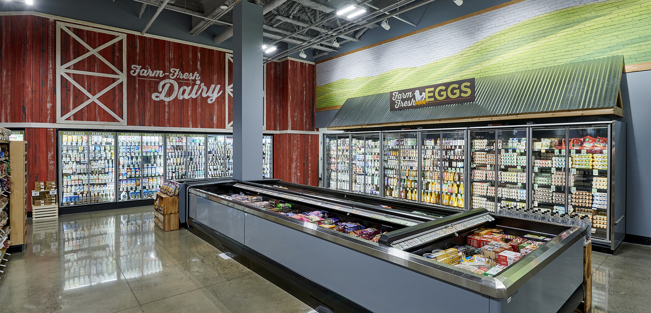 The interior view of the Sprouts Farmers Market showcasing the corner barn and field painted design highlighting the dairy and egg section.