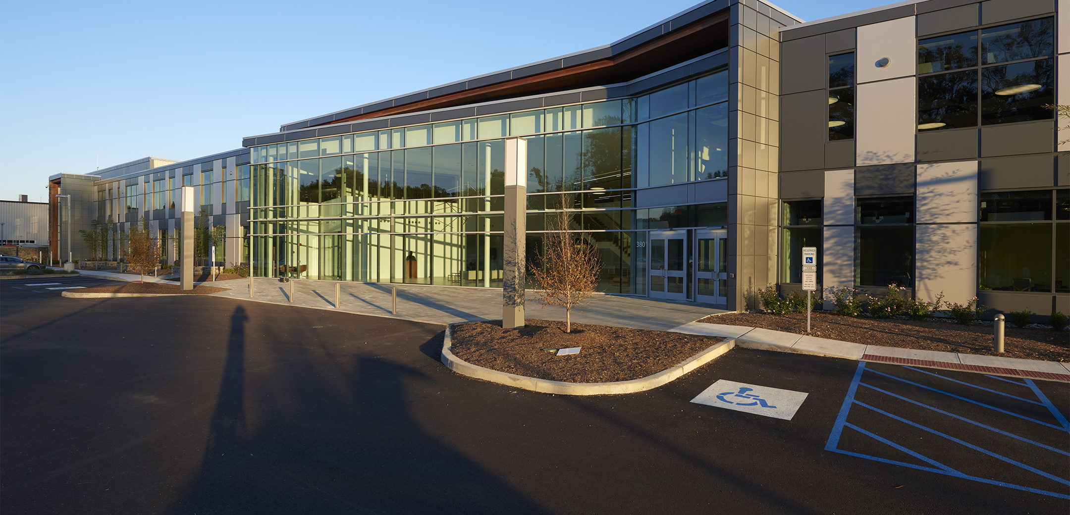 Sunoco headquarters, a two story, modern building featuring a large glass panel wall lobby entrance and front parking lot.