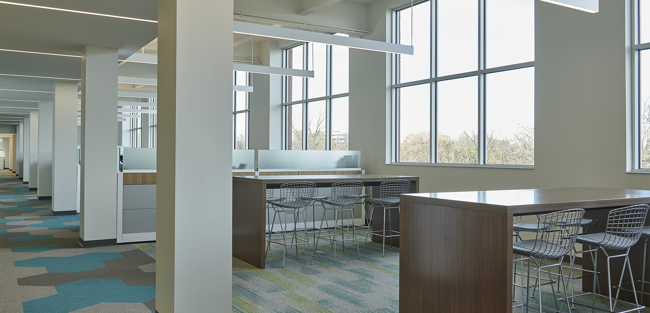 The interior office space of UGI Energy Services featuring large windows and open concept cubicles with metal chairs.