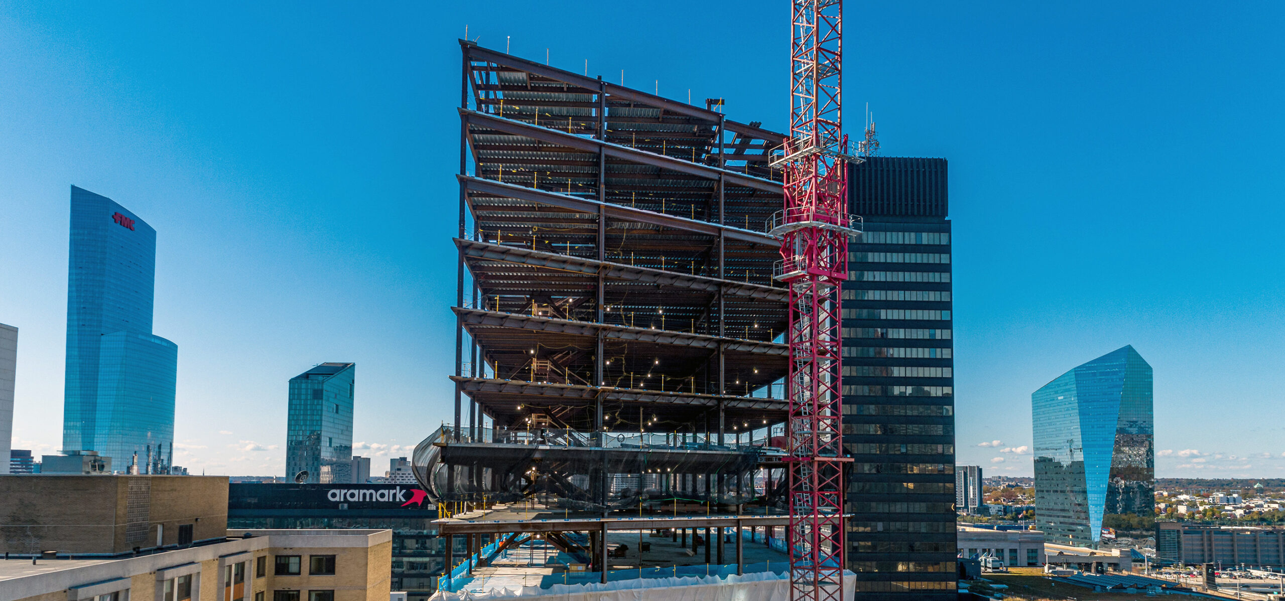 2222 Market Street, a large law firm office building under construction with Philadelphia in the background.