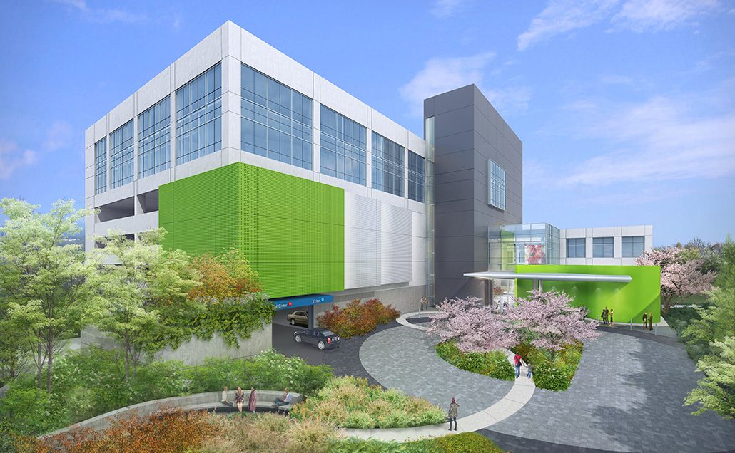 A rendering of the new Main Line Health building with a large gray medical tower and green and white exterior walls.