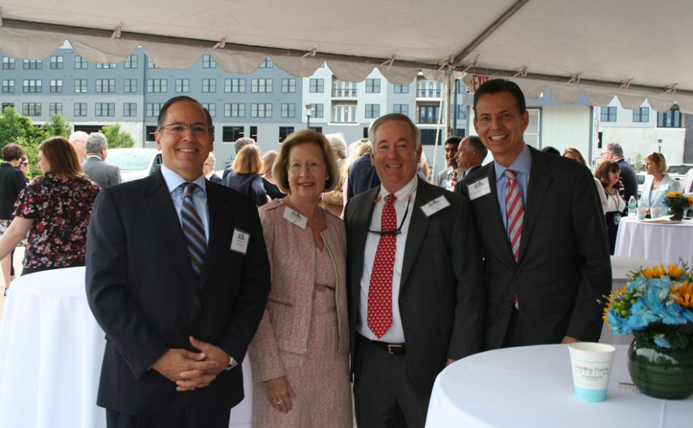 A front facing picture of Rob Cottone and others smiling at the camera in celebration of the ground breaking event.