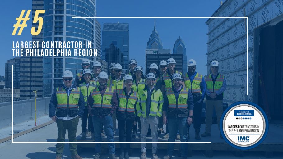 A group of IMC employees posing for a group photo with a blue overlay on top of the photo and text that reads "#5 Largest Contractor in the Philadelphia Region".