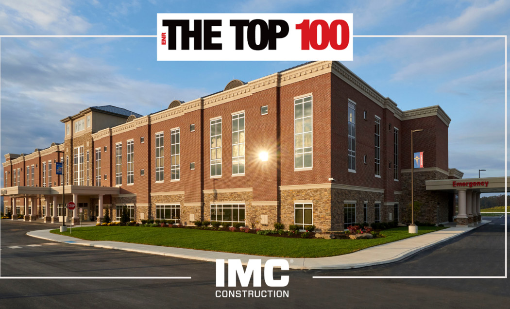 Exterior view of hospital with IMC logo and ENR top 100 logo