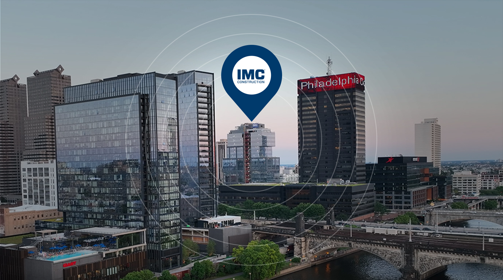 A graphic of the city of Philadelphia with a blue location marker with a white IMC Construction logo above 2222 Market Street office tower