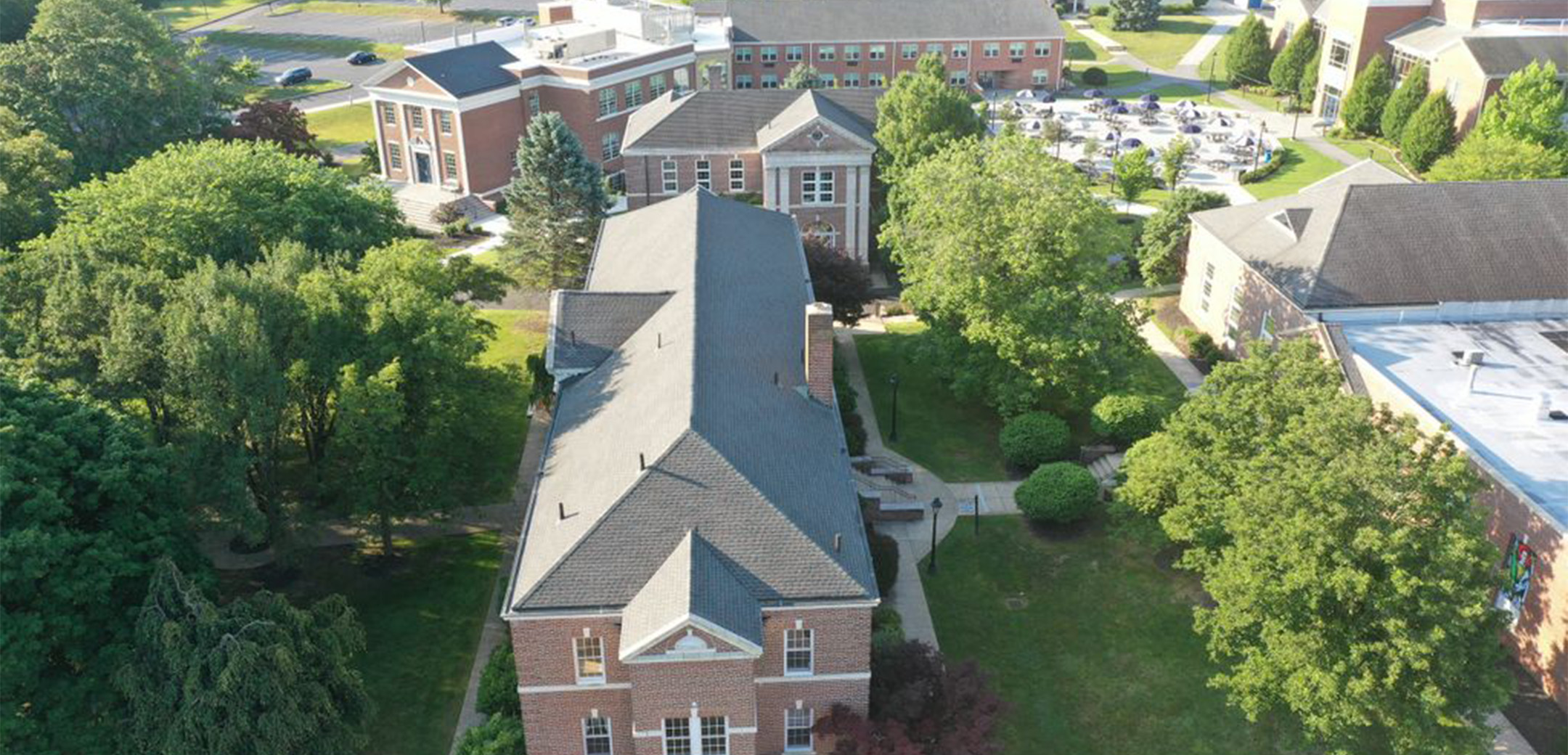 An aerial view of Malvern Preparatory School's Campus with brick buildings and trees