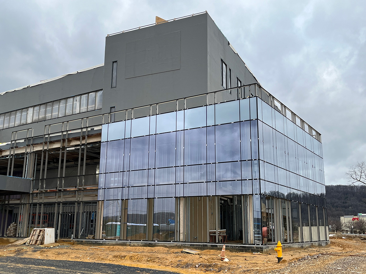 The exterior of Good Shepherd's Rehabilitation Hospital featuring the front of the gray brick hospital and panes of glass covering the bottom of the facility