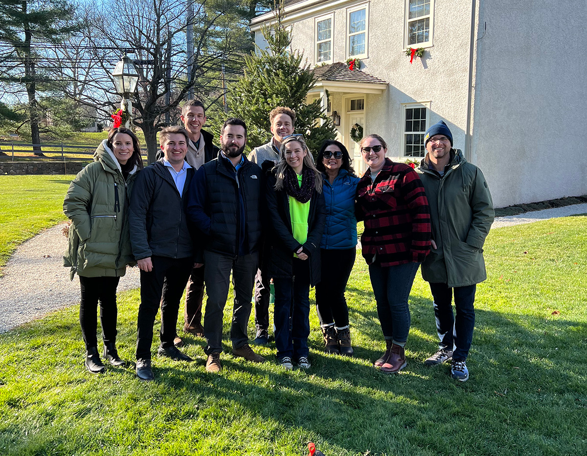 A group photo of several IMC employees posing for a photo