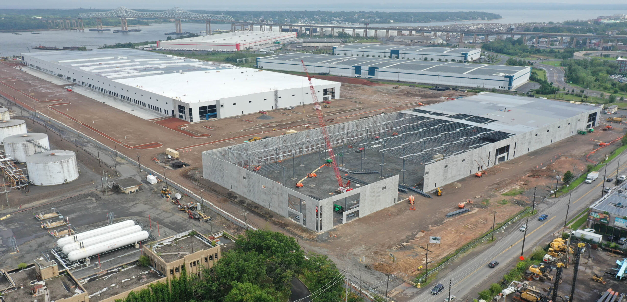 Two warehouses being built by bridge from New York to New Jersey