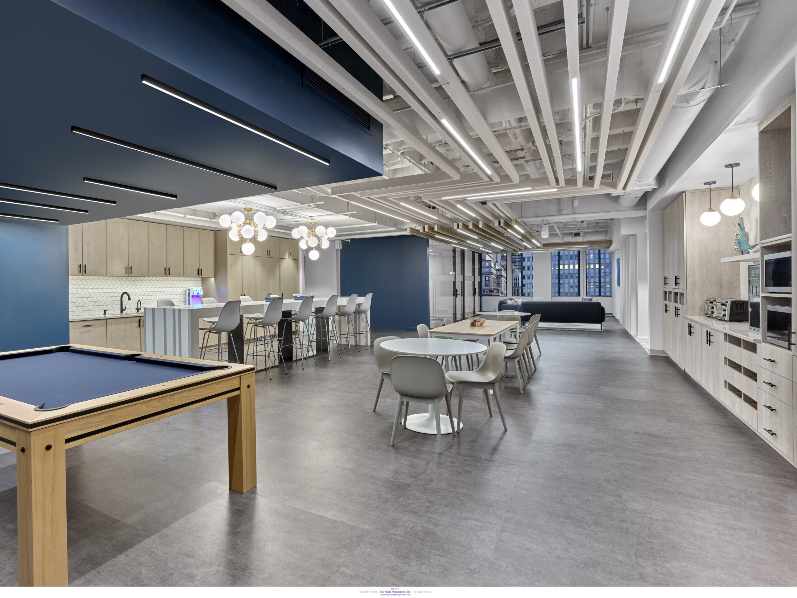 Indoor office area with blue ceiling and tables