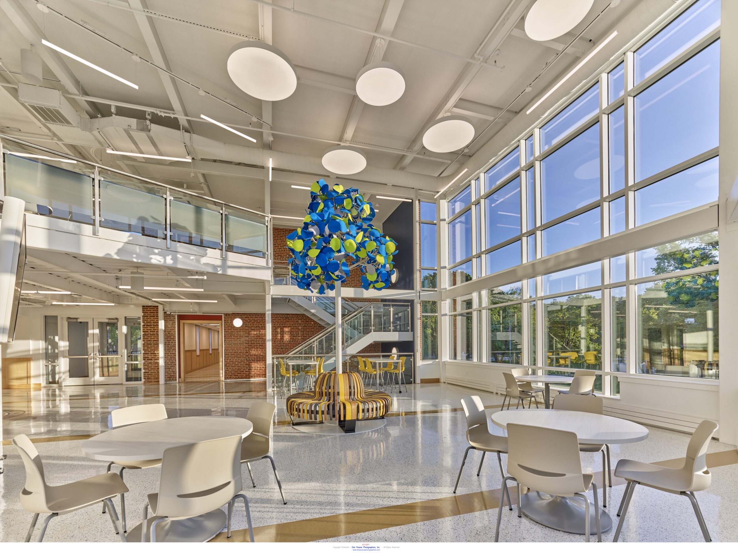 open lit indoor foyer with blue and green lighting fixture