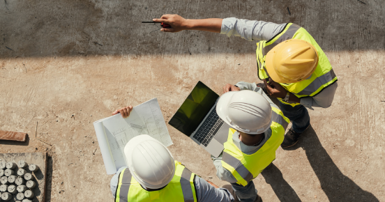 Aerial view of people discussing plans on a construction site